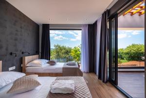 a bedroom with two beds and a large window at Stromboli in Sveti Petar +103 photos