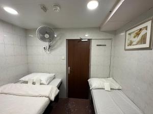 Ένα ή περισσότερα κρεβάτια σε δωμάτιο στο Mandarin Guest House