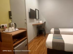 TV a/nebo společenská místnost v ubytování Singgah Pengerang Hotel