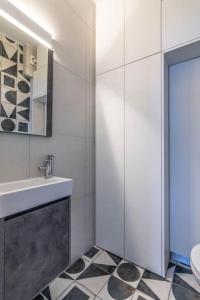 a white bathroom with a sink and a toilet at Light in Athens +21 photos