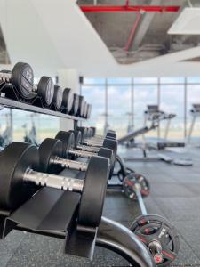 a row of dumbbells on a rack in a gym at Hue Charm Apartment with Pool and Gym in Thôn Văn Dương
