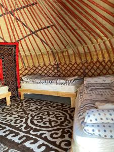 a bedroom with two beds in a yurt at Yurt camp Sonun in Bokonbayevo