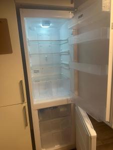 un frigorifero vuoto con la porta aperta in una cucina di FORNELLS 003 a Es Mercadal
