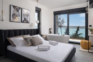 a bedroom with a large white bed and a bath tub at Soho in Punta +54 photos