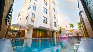 a swimming pool in front of a building at Lara Vista Hotel Suits & Spa in Antalya