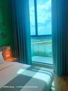 Postel nebo postele na pokoji v ubytování Singgah Pengerang Hotel