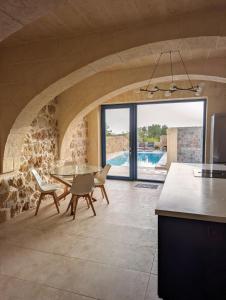 a kitchen and dining room with a table and chairs at Sea Holly Gozo in Nadur