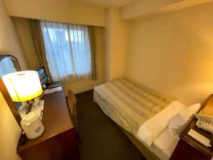 a hotel room with a bed and a window at Ichihara Marine Hotel in Ichihara