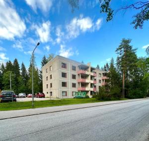 a building on the side of a road with a street light at Pearl of Helokka in Jyväskylä