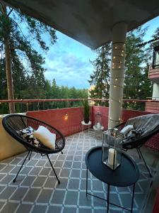 a patio with two chairs and a table on a balcony at Pearl of Helokka in Jyväskylä