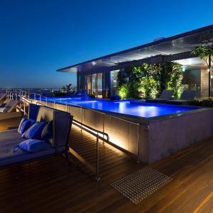 a large swimming pool in a house at night at Luxury 2 Bedroom 2 Bathroom in the heart of South Brisbane in Brisbane