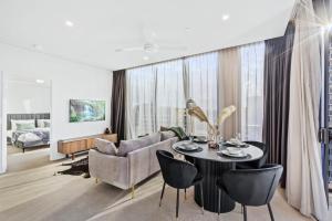 a living room with a table and a couch at Luxury 2 Bedroom 2 Bathroom in the heart of South Brisbane in Brisbane