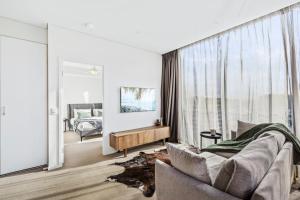 a living room with a couch and a large window at Luxury 2 Bedroom 2 Bathroom in the heart of South Brisbane in Brisbane