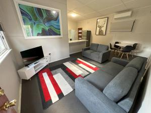 a living room with a couch and a tv at 2 Bedroom Apartment near Graftons Waterfront in Grafton