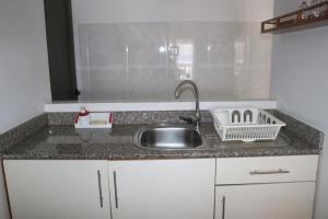 a kitchen with a sink and a counter top at Marie-France Beach Front Apartments in La Digue +28 photos