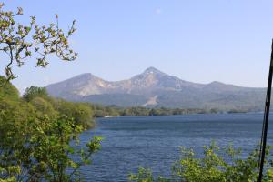 a view of a lake with mountains in the background at Urabandai Cranes in Kitashiobara