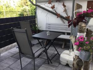 une table et des chaises sur une terrasse avec un banc dans l'établissement Ferienhaus Absmeier, à Bad Griesbach im Rottal