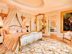 a bedroom with a king sized bed with a canopy at Bilgah Beach Hotel in Baku