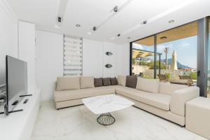 a living room with a couch and a tv at Eco Villa ECE in Kalkan