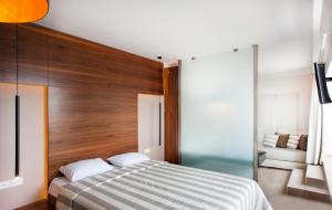 a bedroom with a bed with a wooden headboard at Frideriki Studios & Apartments in Platanias