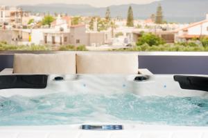 bañera de hidromasaje en el balcón con vistas a la ciudad en Frideriki Studios & Apartments, en Plataniás