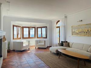 a living room with a couch and chairs and a fireplace at Sea view Villa La Alcaidesa in La Alcaidesa +51 photos