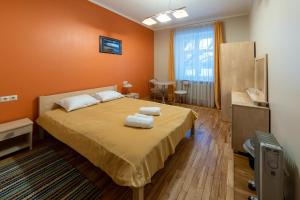 a bedroom with a bed with two towels on it at Šlokenbekas Muiža in Milzkalne
