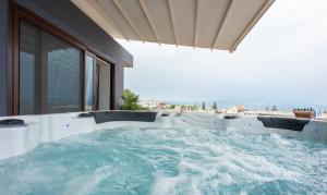 a jacuzzi tub in a room with a view at Frideriki Studios & Apartments in Platanias