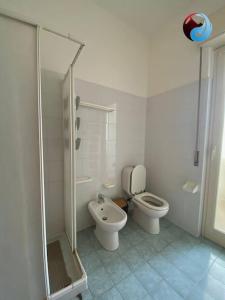 a white bathroom with a toilet and a shower at La Dolce Vista, Mitogio(Ct) in Gaggi