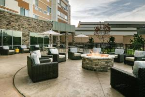 a patio with chairs and a fire pit in front of a building at Courtyard by Marriott Omaha Bellevue at Beardmore Event Center in Bellevue