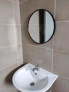 a bathroom with a white sink and a mirror at EZHomestay Platinum near Cyberjaya Putrajaya KLIA in Kampung Dengkil