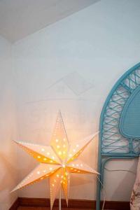 a star decoration on a wall next to a bench at La Huertina De Granda in Candanal +70 photos