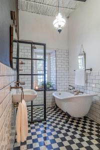 a large bathroom with a tub and a sink at The Victorian of Church Street - Cape Dutch Quarters in Tulbagh