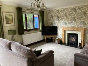 a living room with a couch and a fireplace at The Willows 