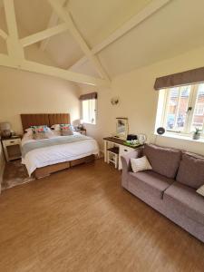 a bedroom with a bed and a couch at Kings Head in North Lopham