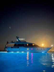 a boat sitting in the water at night at Riti Yacht in Kalkara