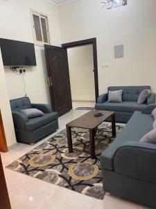a living room with two couches and a coffee table at شقق بن طالب in Khamis Mushayt