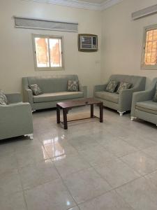 a living room with couches and a coffee table at شقق بن طالب in Khamis Mushayt