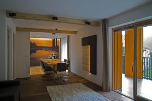 a living room with a dining room table and a view at La vie Deluxe - Private Luxury Apartments in Campo Tures