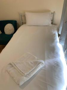 uma cama branca com duas toalhas em Spring em Whetstone