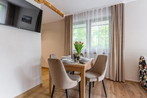 ein Esszimmer mit Tisch und Stühlen und einem Fenster in der Unterkunft Poza Szlakiem in Zakopane