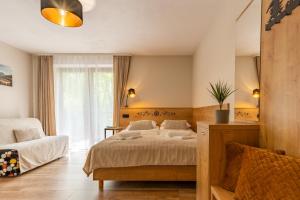 ein Schlafzimmer mit einem Bett und einem Stuhl und einem Fenster in der Unterkunft Poza Szlakiem in Zakopane