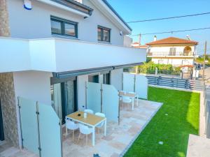 a view of the patio of a house with a table and chairs at Dream Luxury Apartments in Stavros