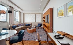 a living room with a couch and a table at Sheraton Baku Intourist in Baku