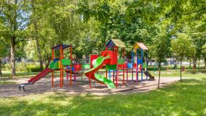 a playground with a colorful slide in a park at Apartamenty Sun & Snow Belnihel in Hel