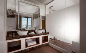 a bathroom with two sinks and a mirror at Sheraton Baku Intourist in Baku