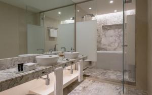 a bathroom with two sinks and a shower at Sheraton Baku Intourist in Baku