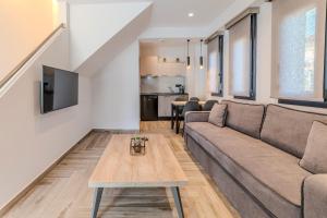 a living room with a couch and a table at Dream Luxury Apartments in Stavros