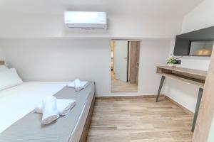 a small room with a bed and a tv at Dream Luxury Apartments in Stavros +23 photos