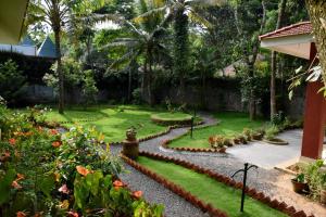 a garden with rocks and flowers in a yard at Green View in Thekkady